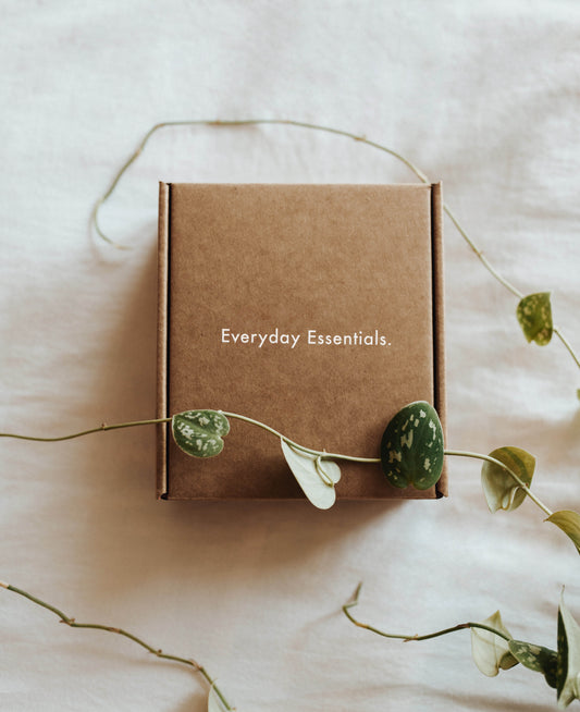 Coffret cadeau en carton kraft entouré de feuillage
